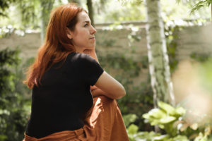 Woman sitting on a step in her garden