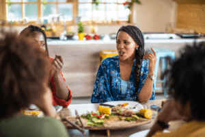Friends connecting over a vegan meal as they find balance in their life